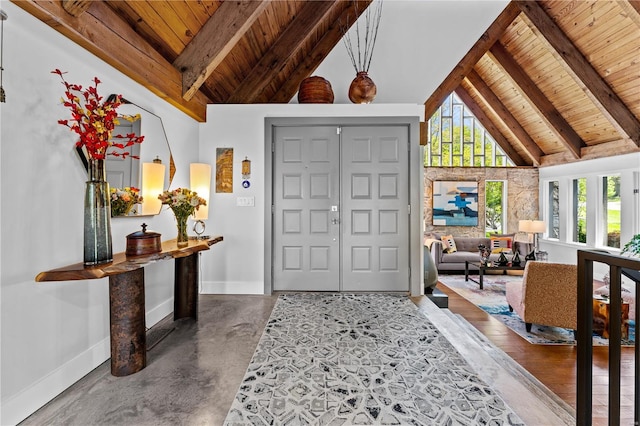 entrance foyer with wood ceiling, a wealth of natural light, and beamed ceiling