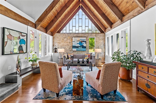 interior space featuring plenty of natural light, beam ceiling, and hardwood / wood-style flooring