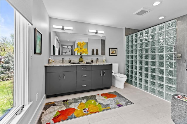 full bath with double vanity, visible vents, tile patterned floors, a walk in shower, and toilet