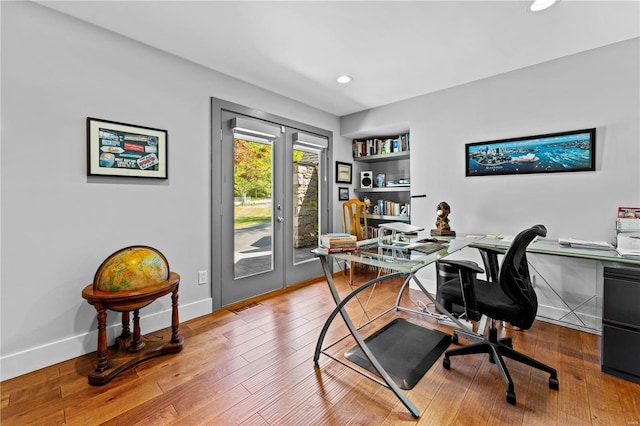 office featuring recessed lighting, baseboards, visible vents, and wood finished floors
