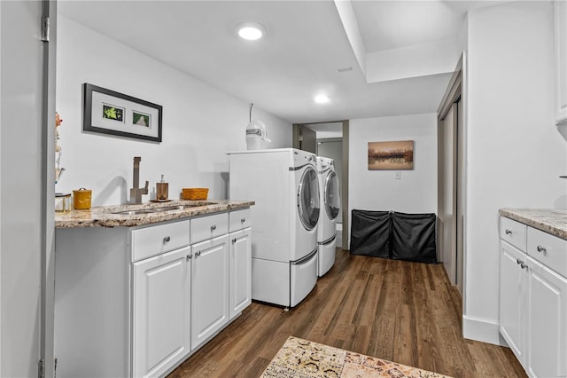 laundry area featuring cabinet space, a sink, separate washer and dryer, dark wood finished floors, and recessed lighting