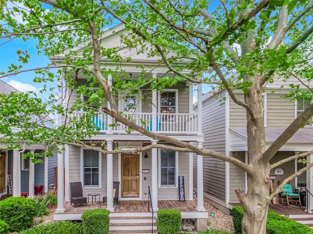 view of front of property with covered porch and a balcony