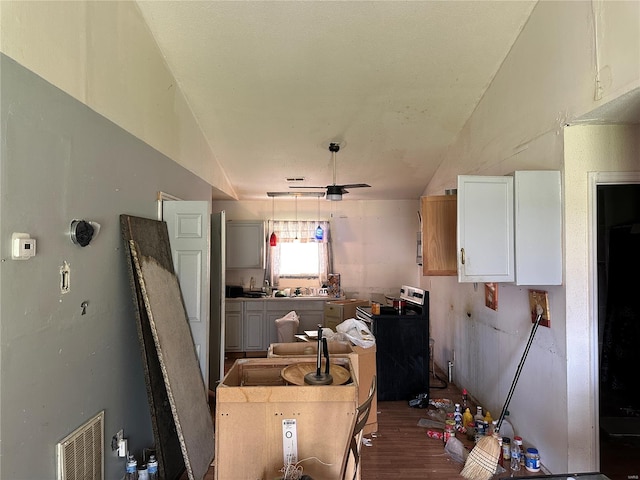 kitchen with visible vents, wood finished floors, lofted ceiling, and electric range oven