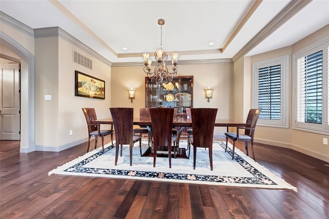 dining space with an inviting chandelier, arched walkways, wood-type flooring, and visible vents