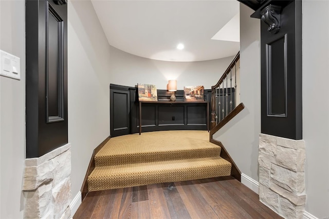 staircase with recessed lighting, baseboards, and wood finished floors
