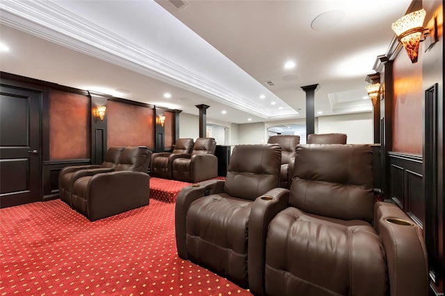 carpeted home theater room featuring crown molding, recessed lighting, a tray ceiling, and decorative columns