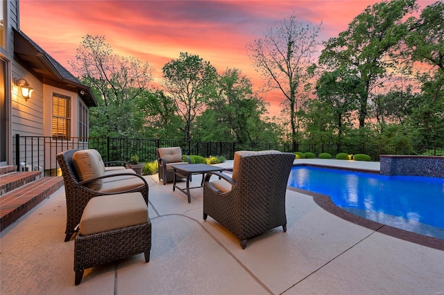 view of swimming pool featuring a patio, a fenced backyard, and a fenced in pool