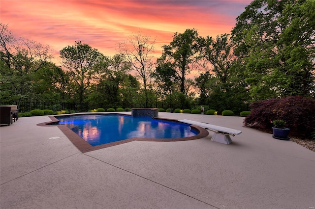 view of pool with a fenced in pool, a diving board, a patio area, and fence