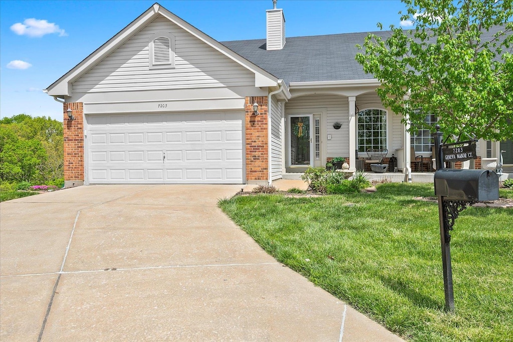 single story home with driveway, a chimney, a front yard, an attached garage, and brick siding