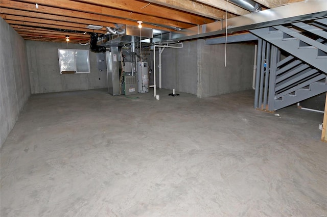 basement featuring water heater, stairway, and heating unit