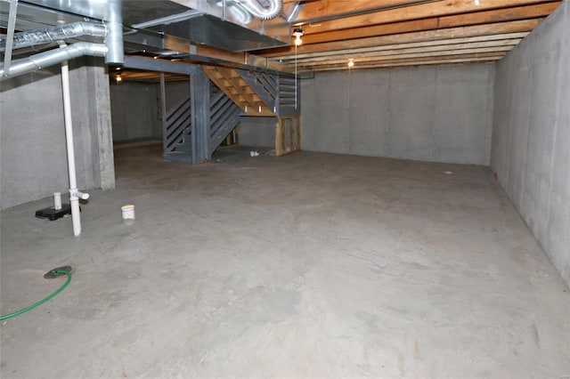 unfinished basement featuring stairs