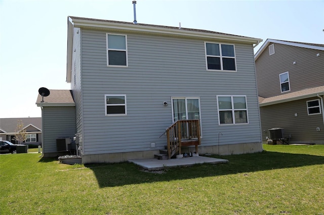 rear view of house featuring a patio, a yard, and central AC unit
