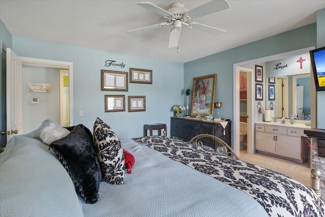 bedroom with a textured ceiling, ceiling fan, and ensuite bathroom