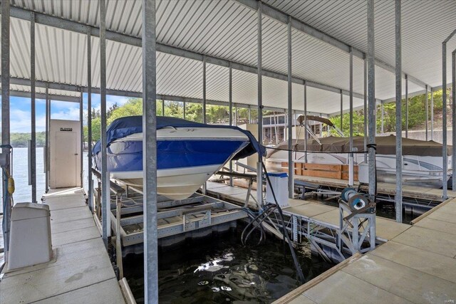 view of dock with boat lift and a water view