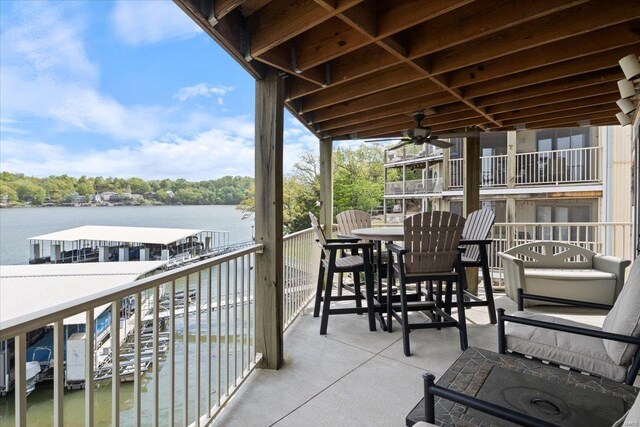 view of patio with a water view and a balcony