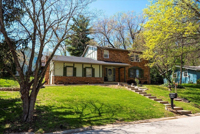 traditional home featuring a front lawn and brick siding