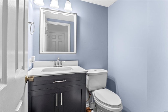 bathroom with toilet and vanity