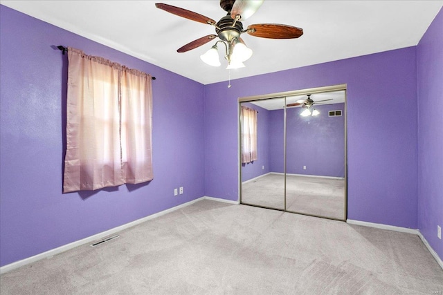 unfurnished bedroom with carpet, visible vents, and baseboards