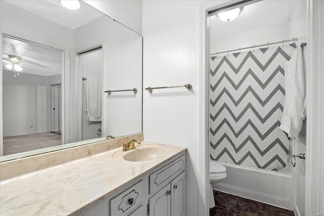 bathroom featuring ceiling fan, toilet, vanity, and shower / tub combo with curtain