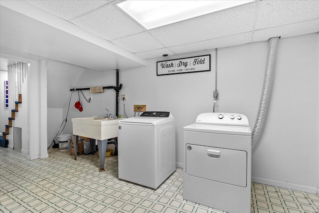 laundry area with light floors, baseboards, laundry area, and separate washer and dryer