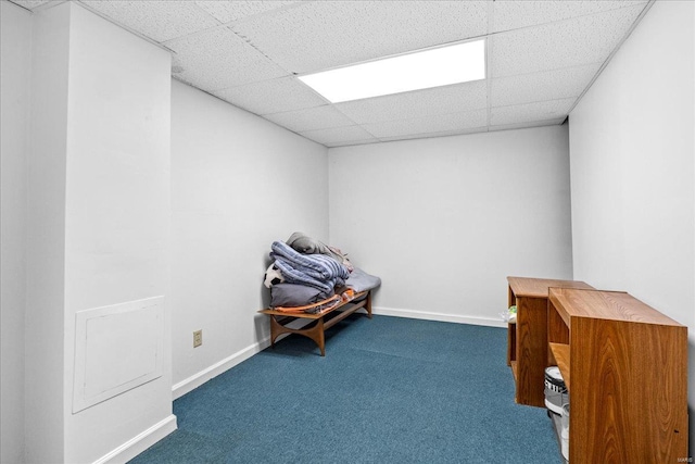 interior space featuring baseboards, carpet flooring, and a paneled ceiling