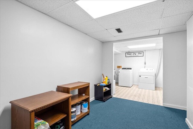 miscellaneous room featuring visible vents, a drop ceiling, baseboards, and separate washer and dryer
