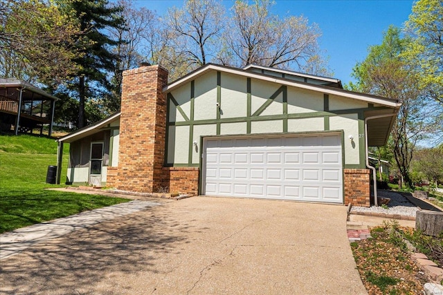 view of front of home with a chimney, driveway, a front yard, a garage, and stucco siding