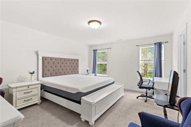 bedroom featuring light colored carpet