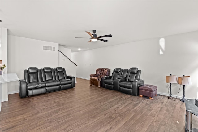 living room with baseboards, a ceiling fan, wood finished floors, and visible vents