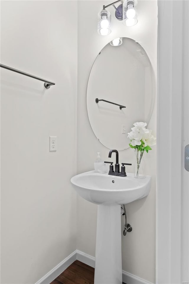 bathroom featuring baseboards and wood finished floors