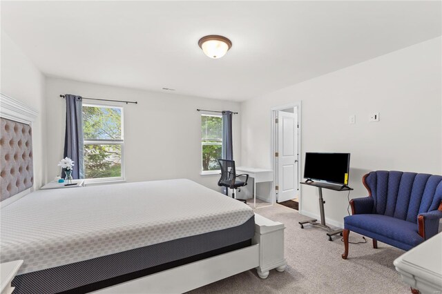 carpeted bedroom featuring baseboards and visible vents