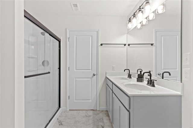 bathroom with a sink, marble finish floor, and a stall shower