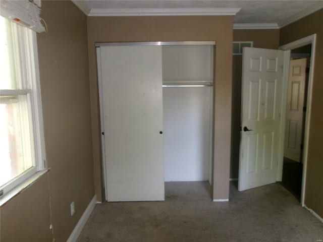 unfurnished bedroom featuring visible vents, carpet flooring, a closet, and crown molding