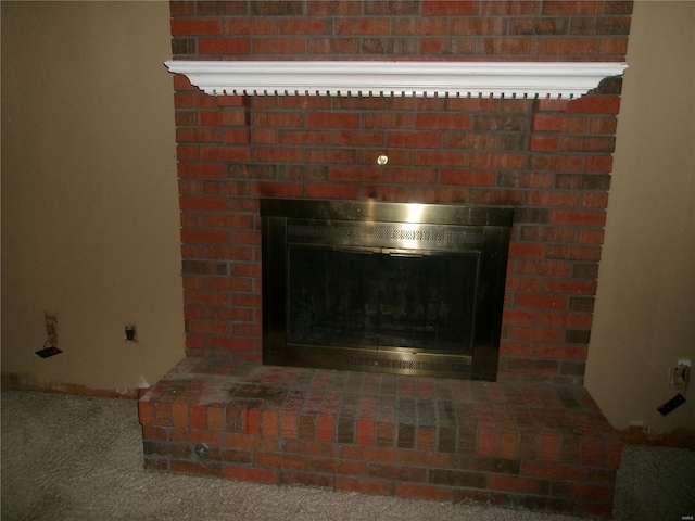 details with a glass covered fireplace and carpet floors