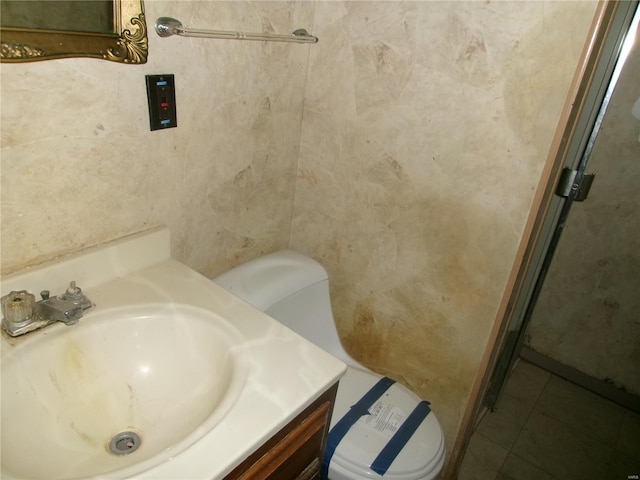 bathroom featuring toilet, vanity, and tile patterned floors