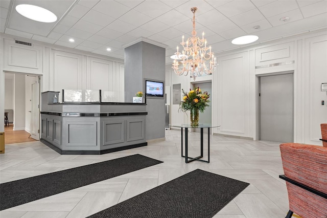 reception with a notable chandelier and visible vents