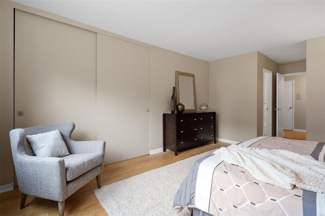 bedroom featuring baseboards and light wood-style flooring
