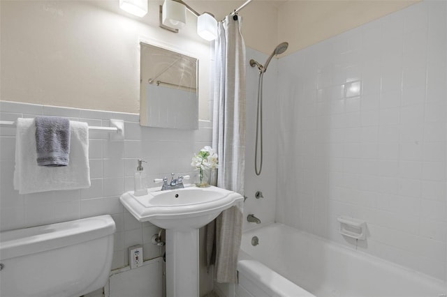 bathroom featuring toilet, a sink, and shower / tub combo