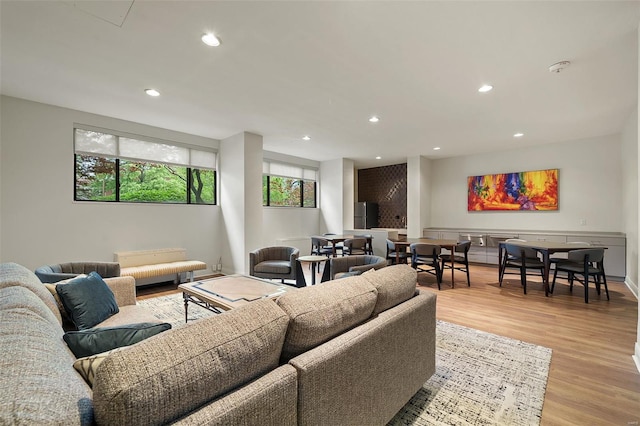 living area featuring light wood-style floors and recessed lighting