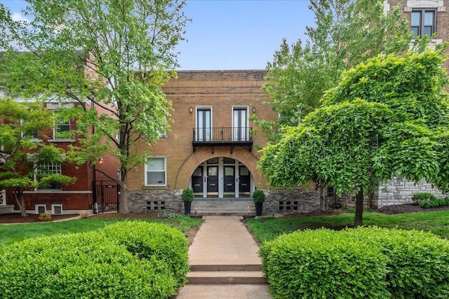 view of front of property with a balcony and stone siding
