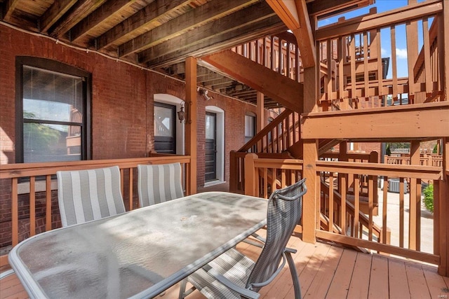 deck featuring stairway and outdoor dining area