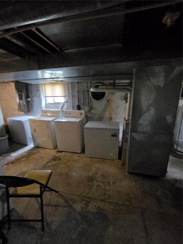 unfinished below grade area with washing machine and clothes dryer and refrigerator