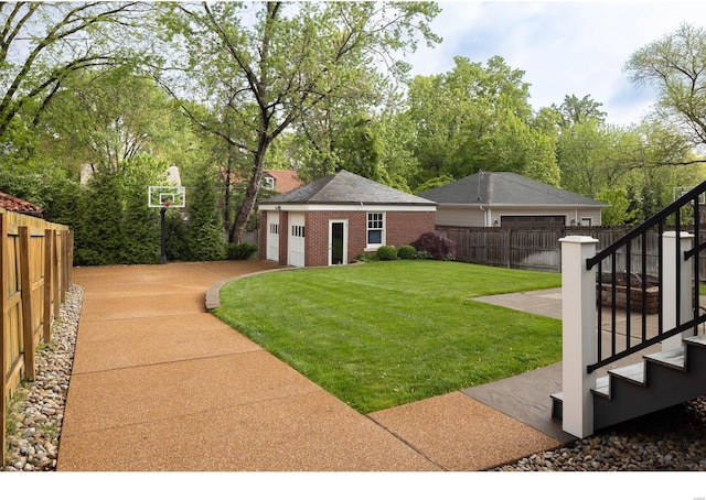 view of yard with fence, an outdoor structure, and stairway
