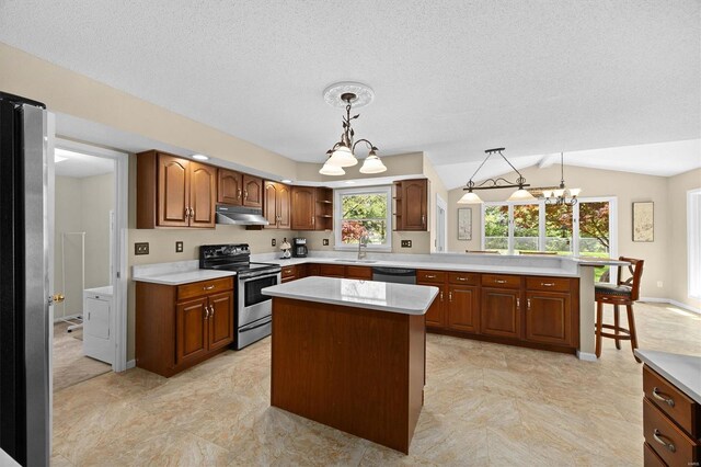 kitchen featuring a sink, stainless steel appliances, light countertops, lofted ceiling, and under cabinet range hood