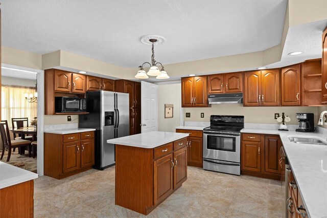 kitchen featuring stainless steel appliances, a sink, a chandelier, brown cabinets, and under cabinet range hood