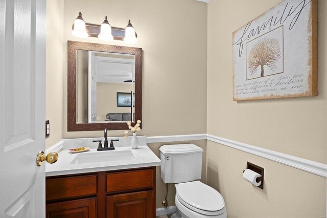bathroom featuring toilet and vanity