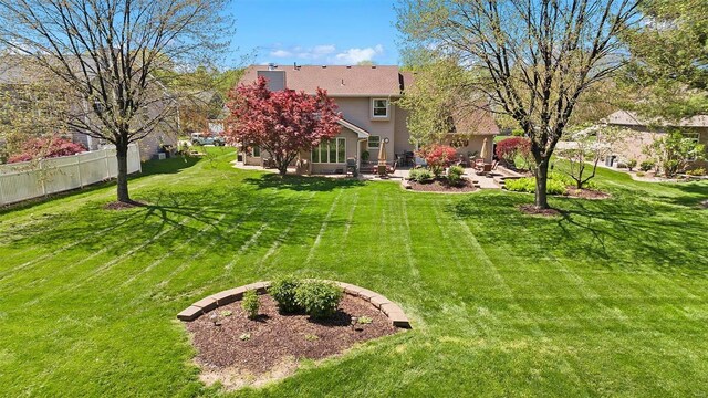 view of yard featuring a patio and fence