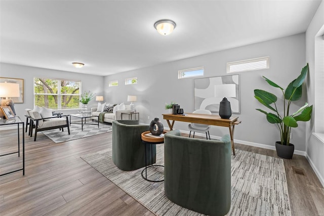 office space with baseboards, plenty of natural light, and wood finished floors