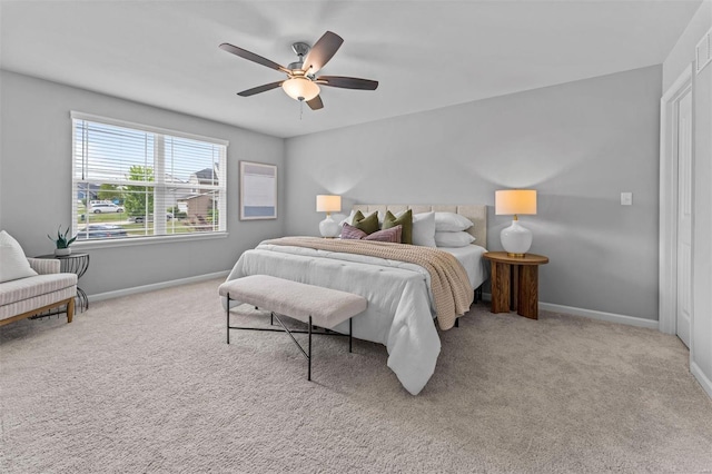 carpeted bedroom with visible vents, baseboards, and ceiling fan