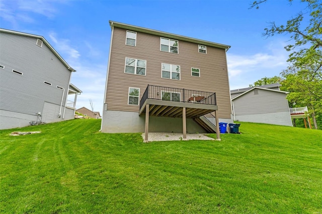 back of property with a yard and a deck
